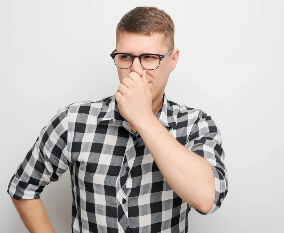 Person looking uncertain about their breath, prompting professional consultation