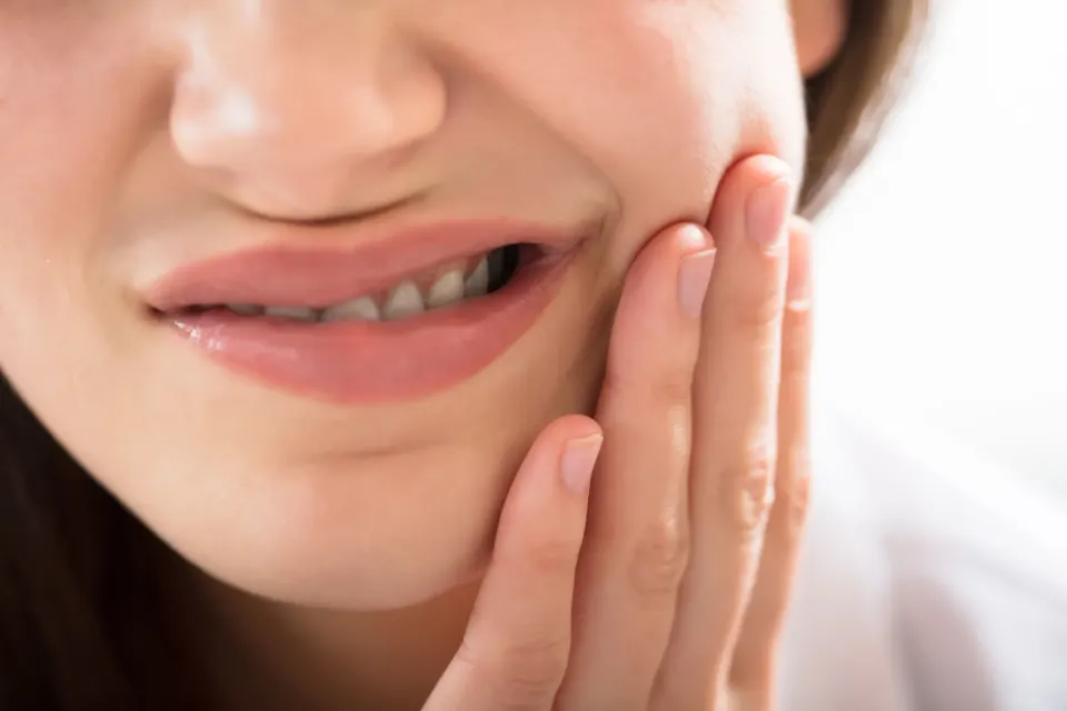 Dentist discussing cavity risk factors with patient at Enclave Dental