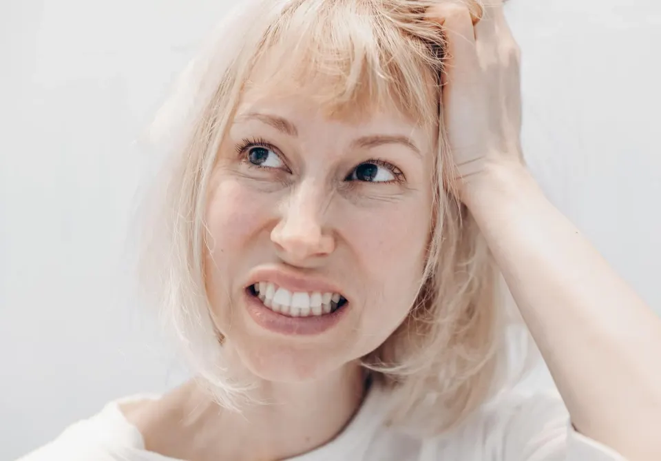 Dentist examining patient's teeth for signs of bruxism wear