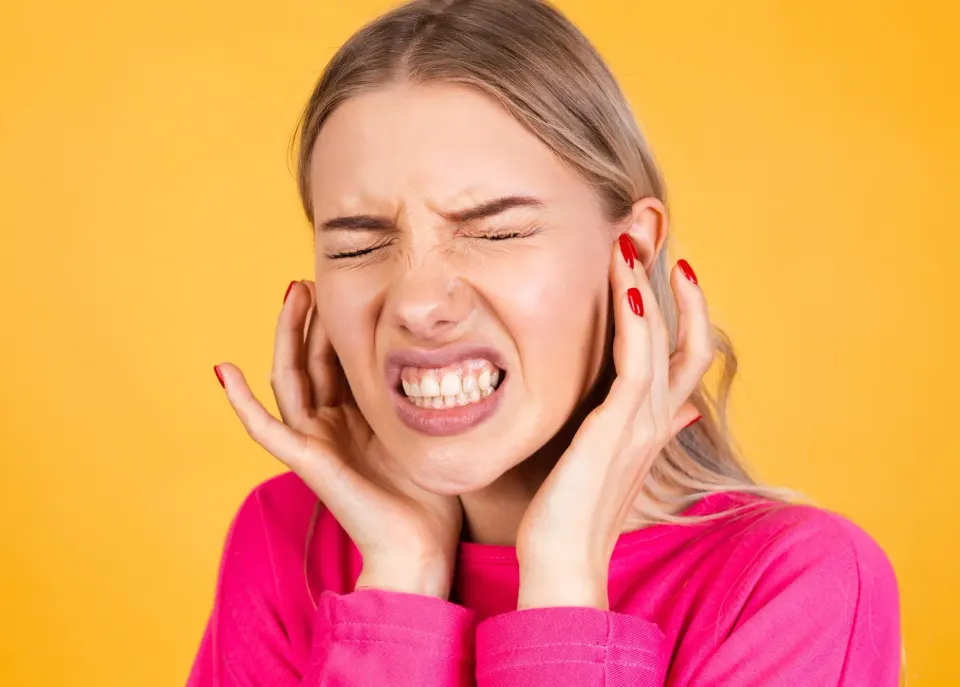 Patient waking up with jaw pain from overnight teeth grinding