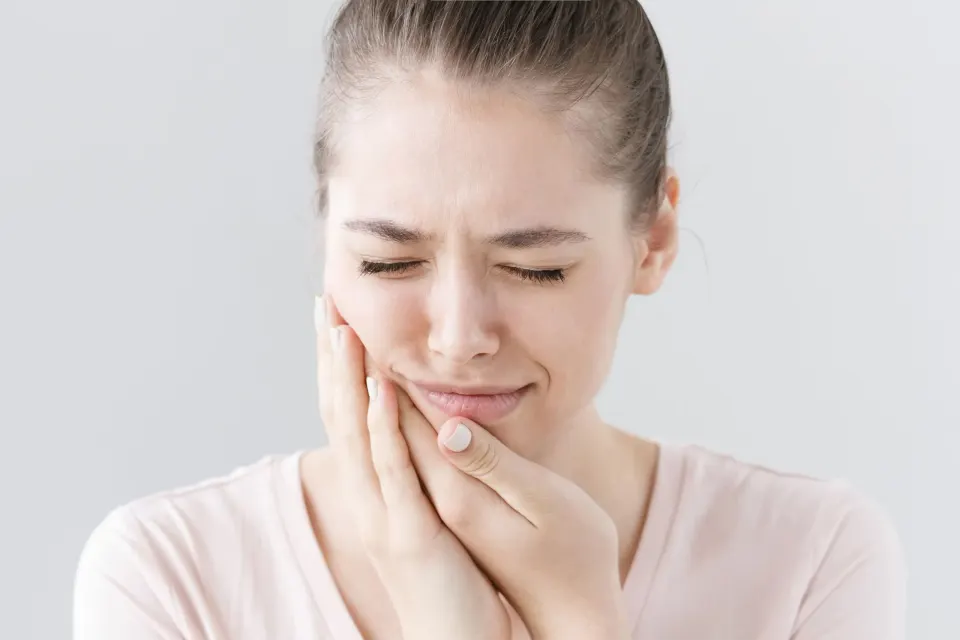 Dental professional examining a patient for tooth pain at Enclave Dental Lake Mary
